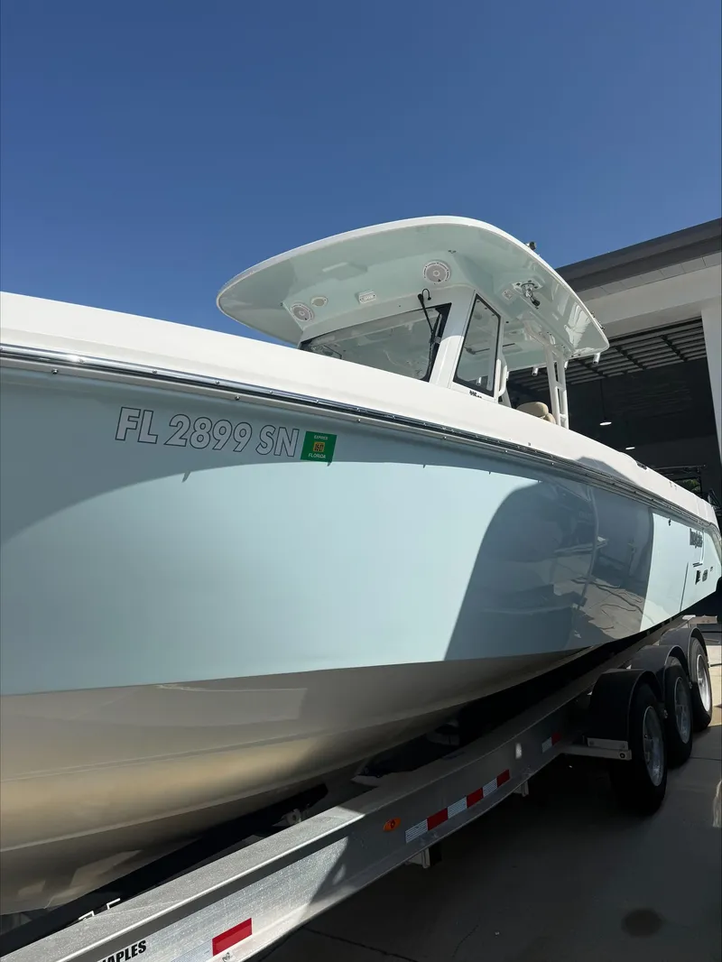 Slide: The Image of A 2020 Everglades 335 Center Console boat on a trailer, ready for the water. - 4