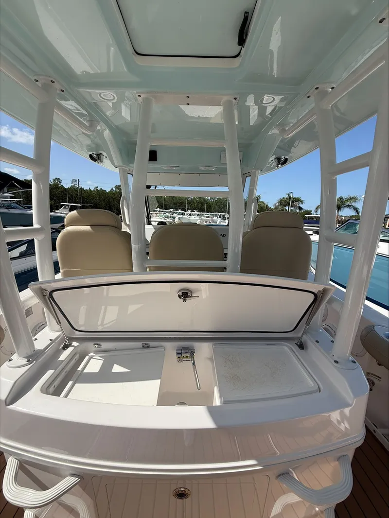 Slide: The Image of The image shows the cockpit of a 2020 Everglades 335 Center Console boat with seating and storage. - 10