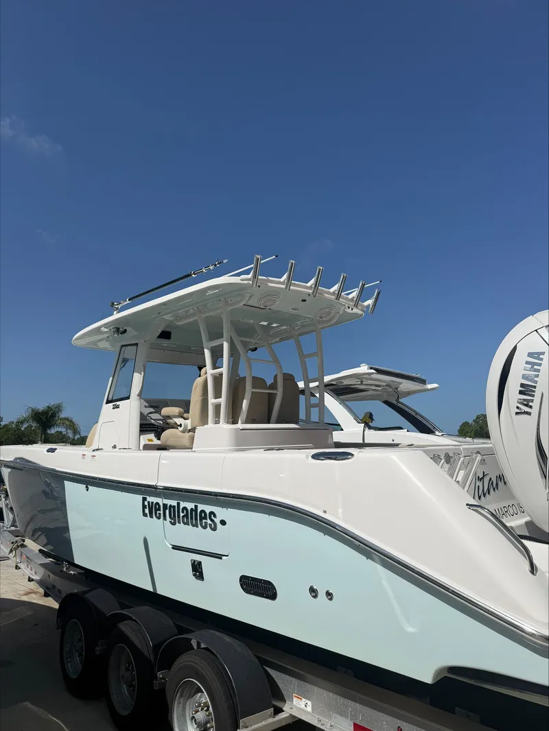 Slide: The Image of An Everglades 335 Center Console boat from 2020 on a trailer under a blue sky. - 5
