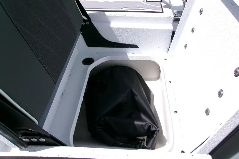 Slide: The Image of Storage compartment in 2027 Xpress H22B Bay boat with black bag inside. - 9