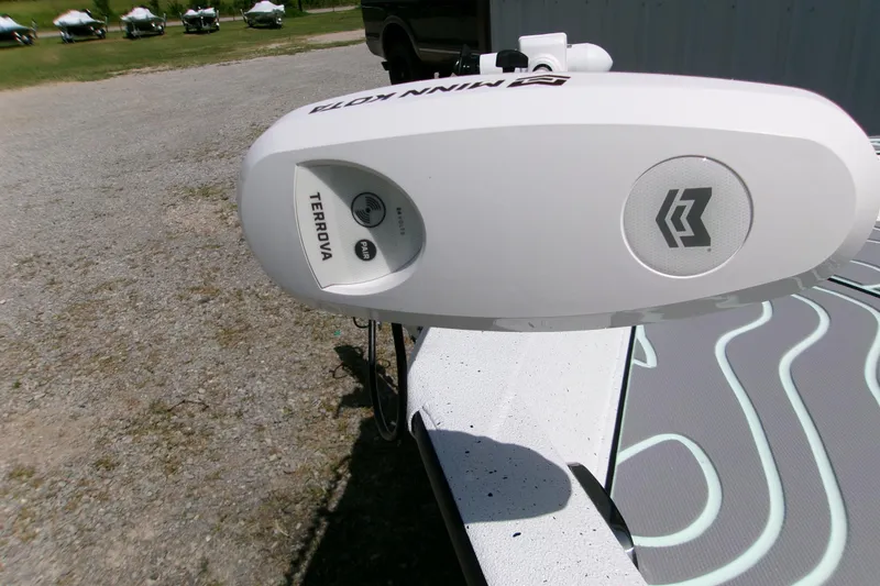 Slide: The Image of 2027 Xpress H22B Bay boat with Minn Kota Terrova trolling motor on gravel surface. - 8
