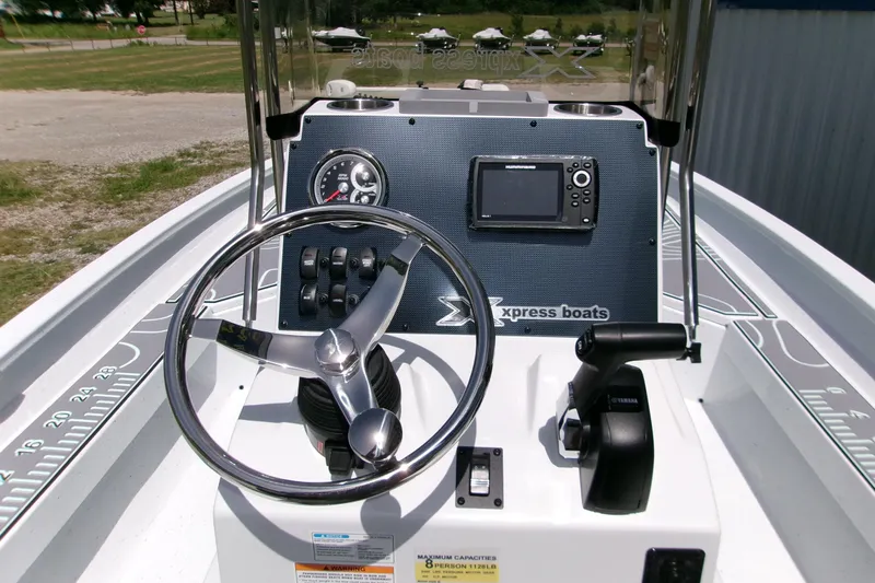 Slide: The Image of Steering console of 2027 Xpress H22B Bay boat with navigation controls. - 23