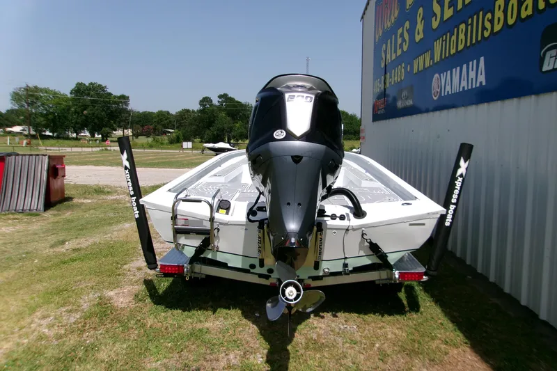 Slide: The Image of 2027 Xpress H22B Bay boat with Yamaha engine, parked outdoors near dealership. - 7