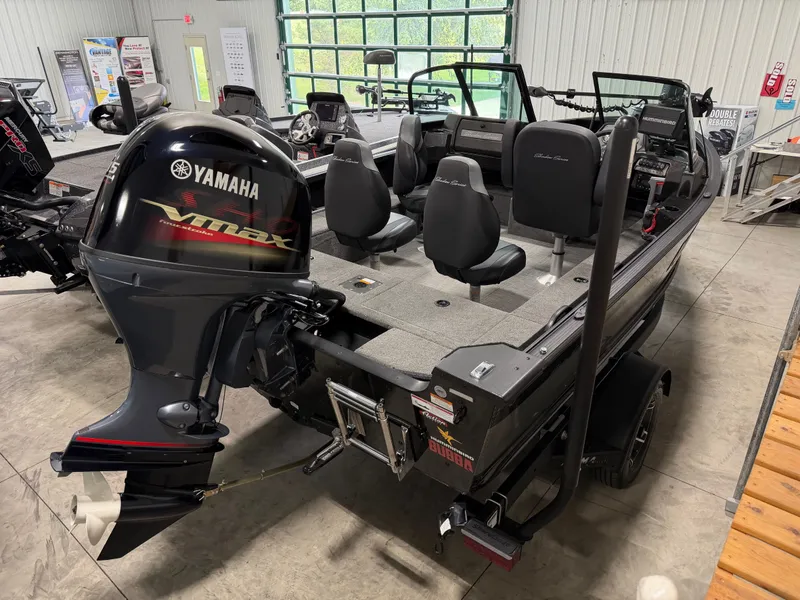 Slide: The Image of The image shows a 2023 Alumacraft Competitor Shadow 175 Sport boat in a showroom. - 4