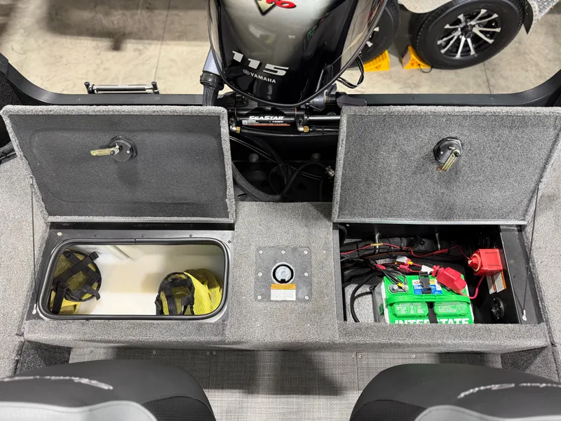 Slide: The Image of The image shows the storage area of an Alumacraft Competitor Shadow 175 Sport boat with batteries and gear. - 22