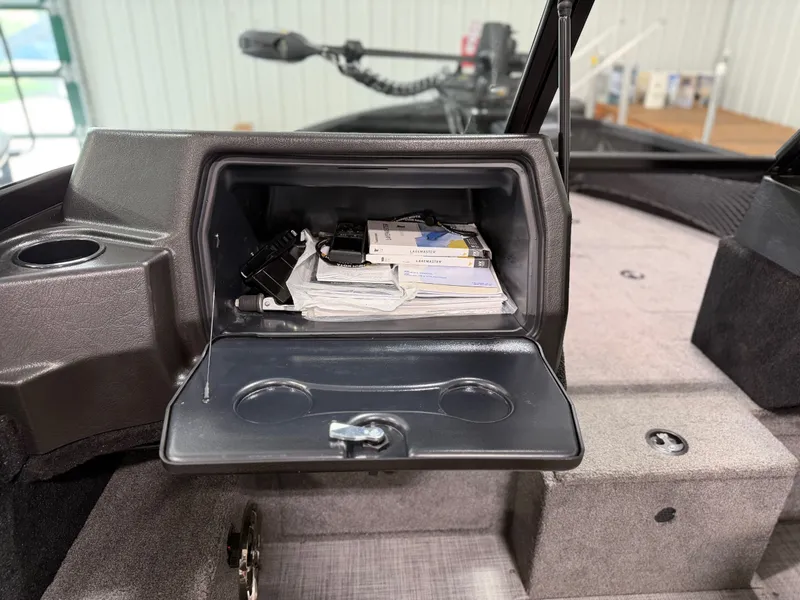 Slide: The Image of The image shows an open storage compartment in an Alumacraft Competitor Shadow 175 Sport boat. - 13