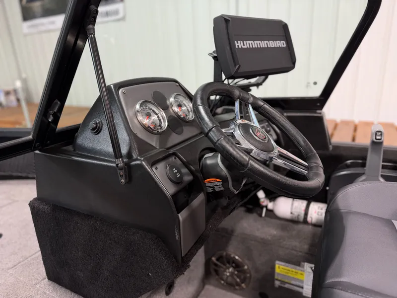 Slide: The Image of The image shows the cockpit of an Alumacraft Competitor Shadow 175 Sport boat with a Humminbird fish finder. - 17