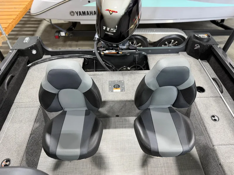 Slide: The Image of Two padded seats in the Alumacraft Competitor Shadow 175 Sport, with a Yamaha 115 engine in the background. - 21