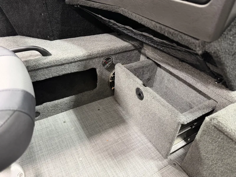 Slide: The Image of Interior of an Alumacraft Competitor Shadow 175 Sport with gray carpet and storage space. - 14