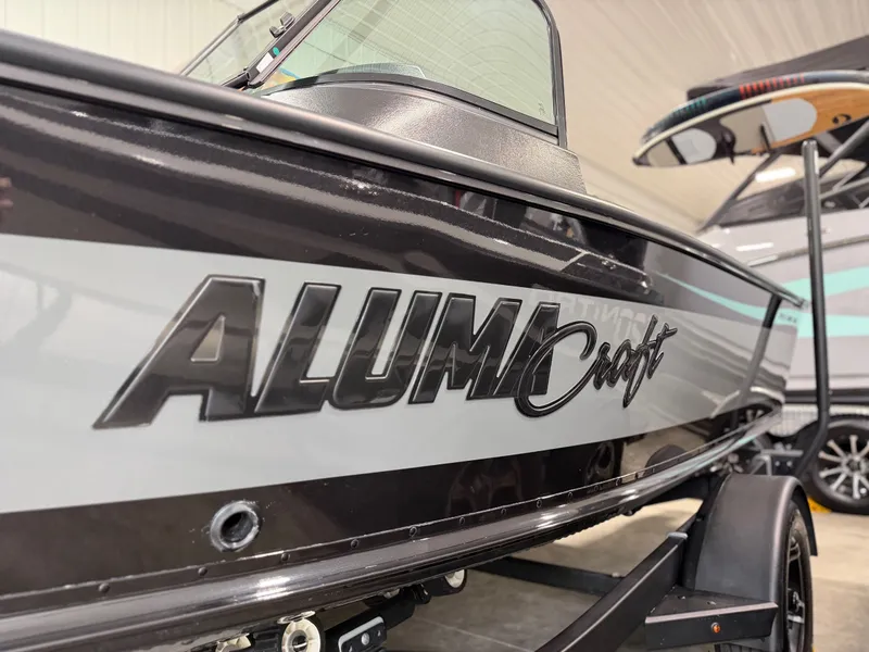 Slide: The Image of Close-up of a 2023 Alumacraft Competitor Shadow 175 Sport boat in a showroom. - 25