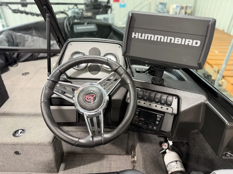 Slide: The Image of The image shows the cockpit of an Alumacraft Competitor Shadow 175 Sport boat with a Humminbird fish finder. - 18