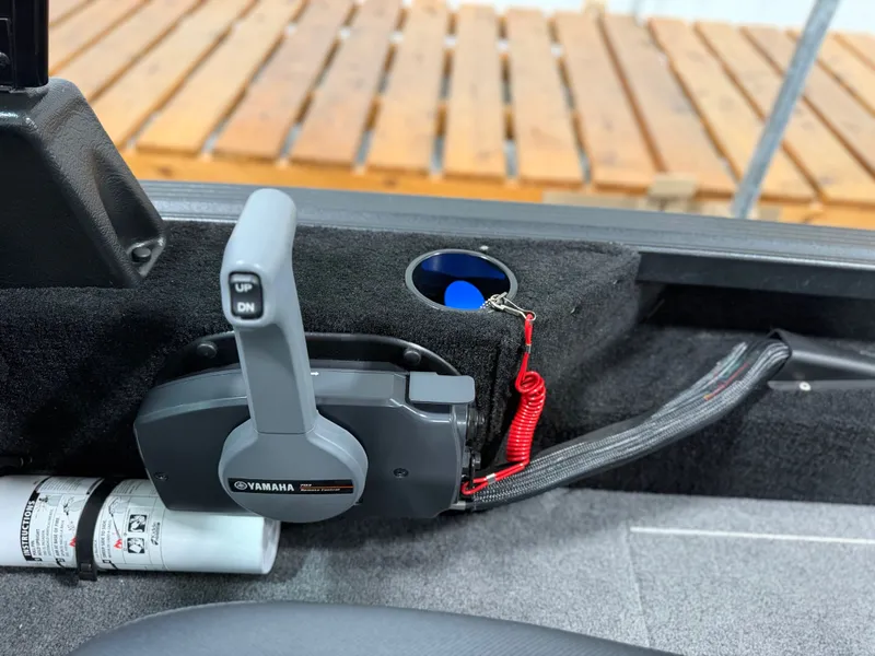 Slide: The Image of Close-up of a throttle lever in an Alumacraft boat, surrounded by gray carpeting. - 20