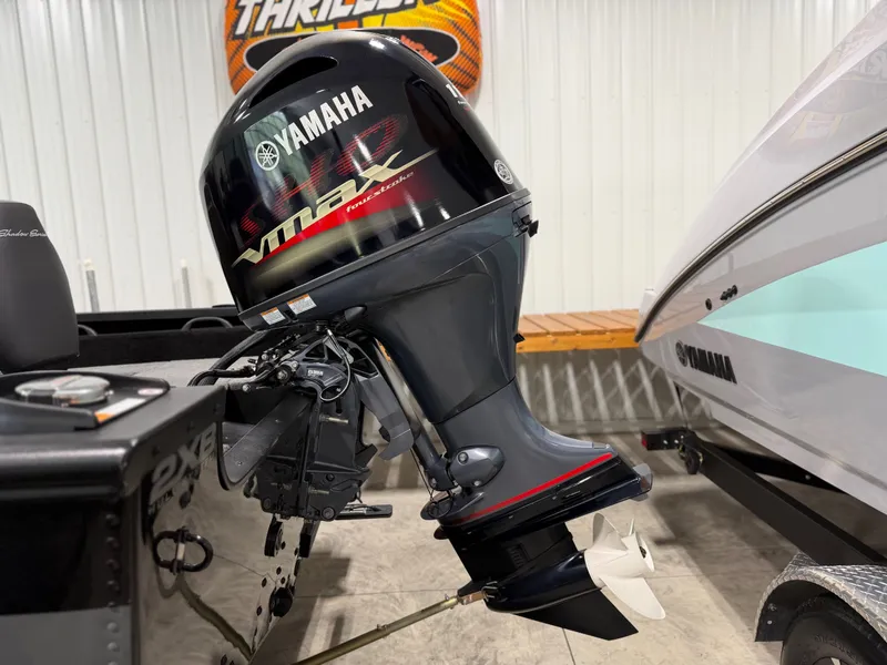Slide: The Image of A Yamaha outboard motor is attached to an Alumacraft boat, situated indoors. - 7