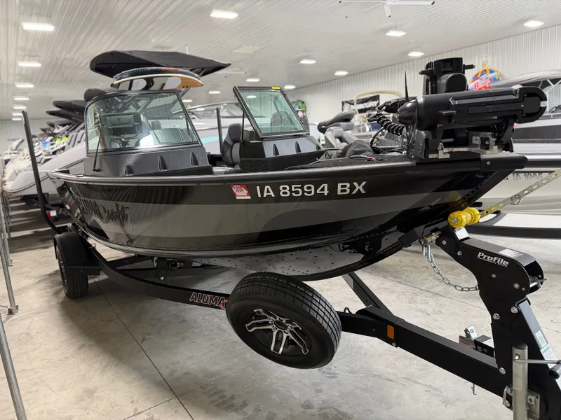 Slide: The Image of A 2023 Alumacraft Competitor Shadow 175 Sport on a trailer in a showroom. - 3