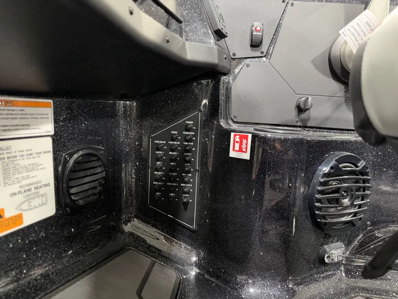 Slide: The Image of Close-up of a boat's dashboard with speakers and switches. - 27