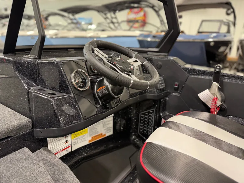 Slide: The Image of The image shows the cockpit of a 2026 Skeeter WXR1910F boat with a modern helm. - 25