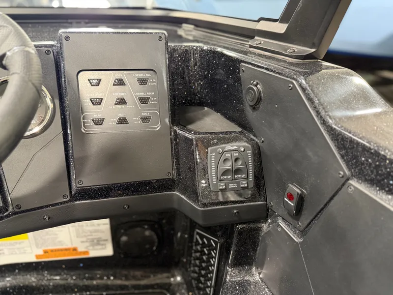 Slide: The Image of Dashboard of a Skeeter WXR1910F boat with switches and controls. - 30