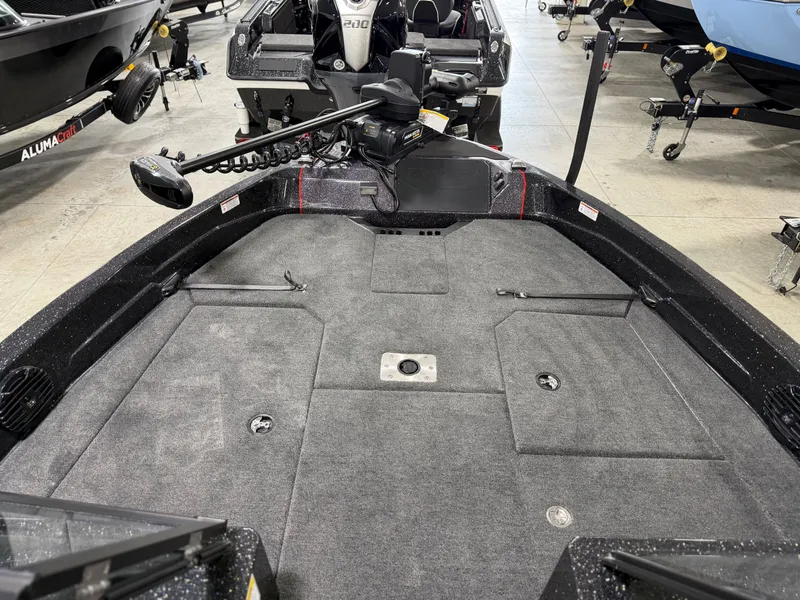 Slide: The Image of The image shows the deck of a 2026 Skeeter WXR1910F boat with gray carpeting. - 13