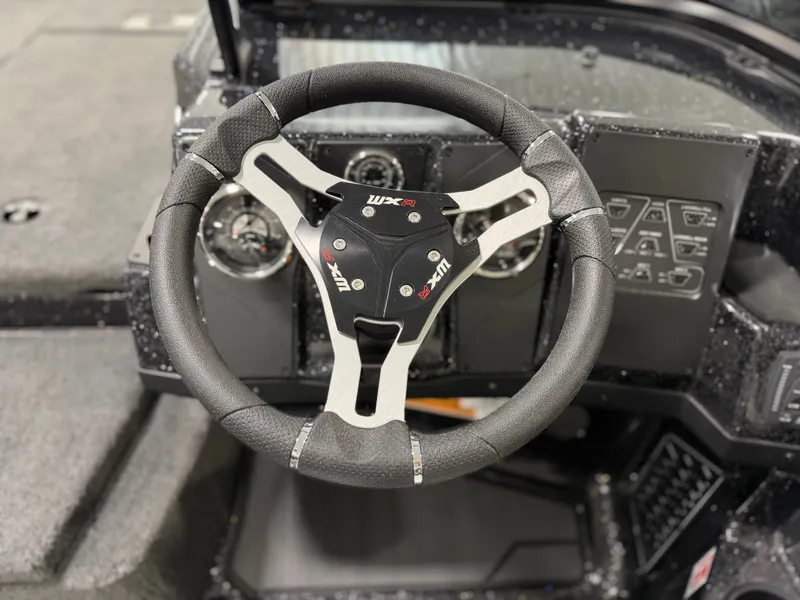 Slide: The Image of The image shows the steering wheel of a 2026 Skeeter WXR1910F boat with modern instruments. - 29