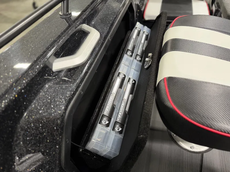 Slide: The Image of Close-up of a boat seat with striped upholstery and side storage for fishing gear. - 31