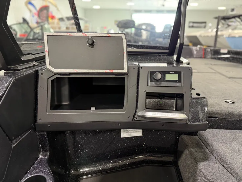 Slide: The Image of The image shows the cockpit of a Skeeter WXR1910F boat with an open storage compartment. - 20
