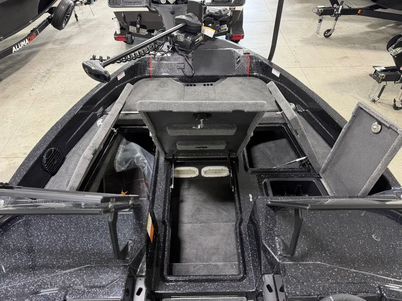 Slide: The Image of The image shows the interior of a Skeeter WXR1910F boat with storage compartments and seating. - 14