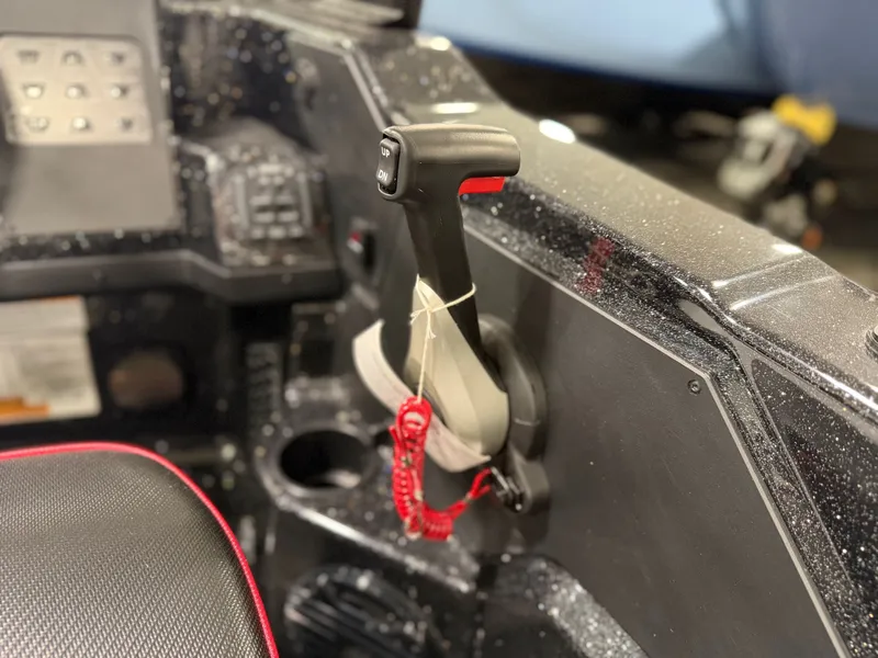 Slide: The Image of Close-up of a boat throttle lever with a red safety cord. - 28