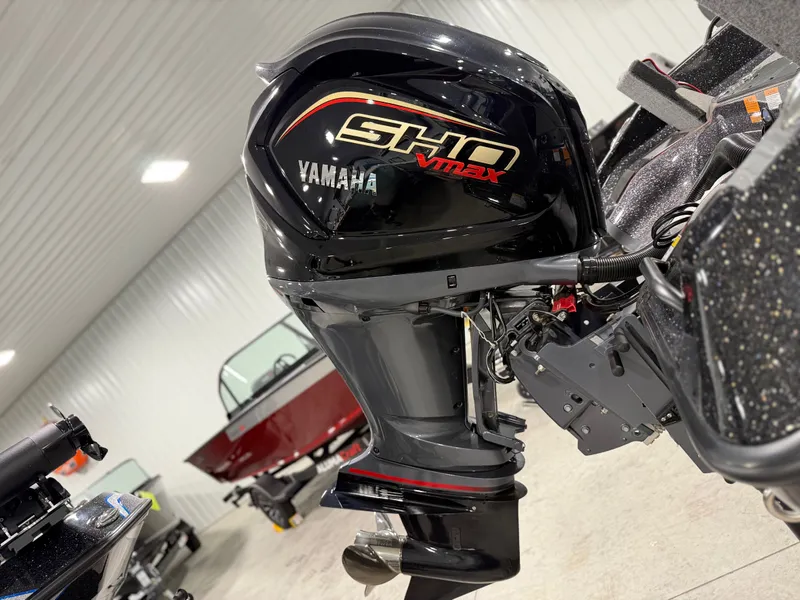 Slide: The Image of A Yamaha SHO Vmax outboard motor is attached to a boat inside a showroom. - 11