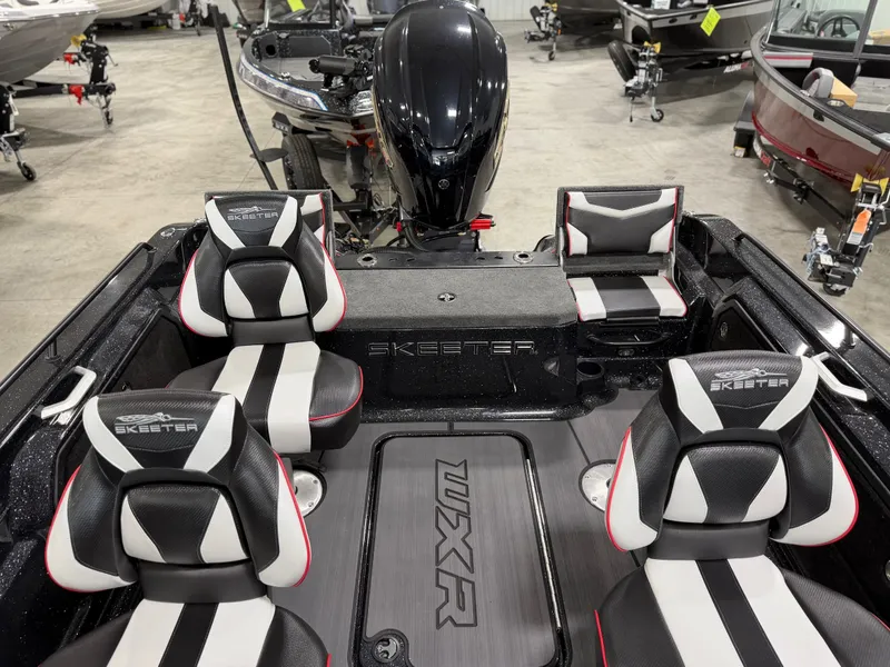 Slide: The Image of The image shows the interior of a Skeeter WXR1910F boat with four black and white seats. - 32