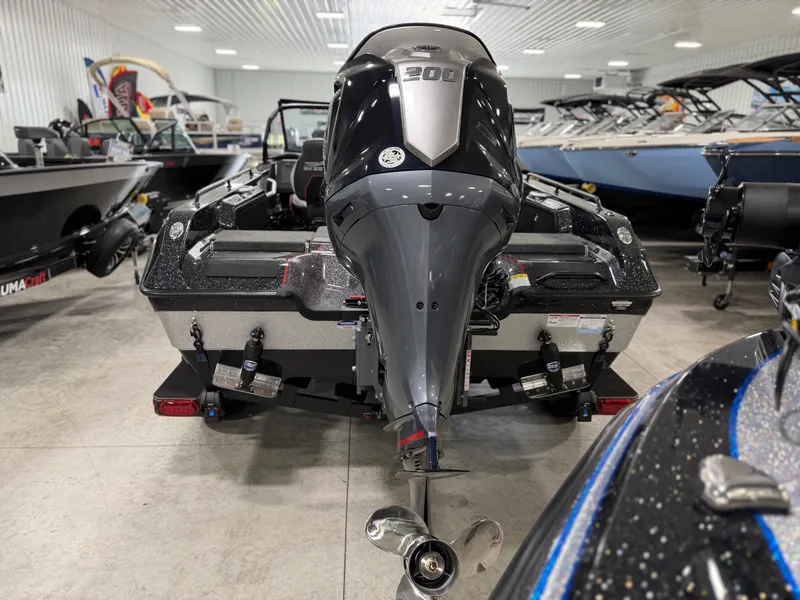 Slide: The Image of A 2026 Skeeter WXR1910F boat with a powerful outboard motor in a showroom. - 9