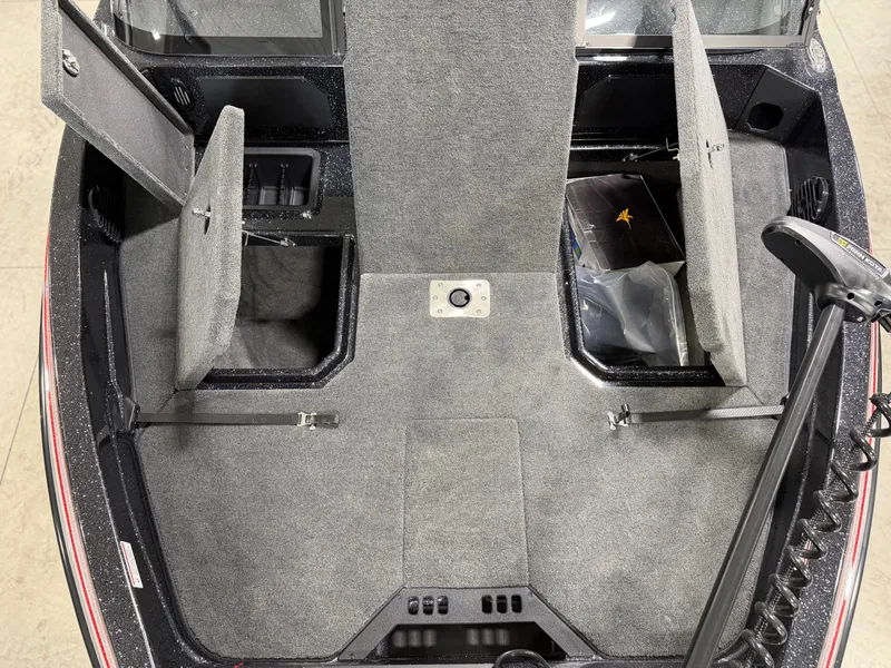 Slide: The Image of The image shows the deck of a Skeeter WXR1910F boat with gray carpeting and storage compartments. - 15