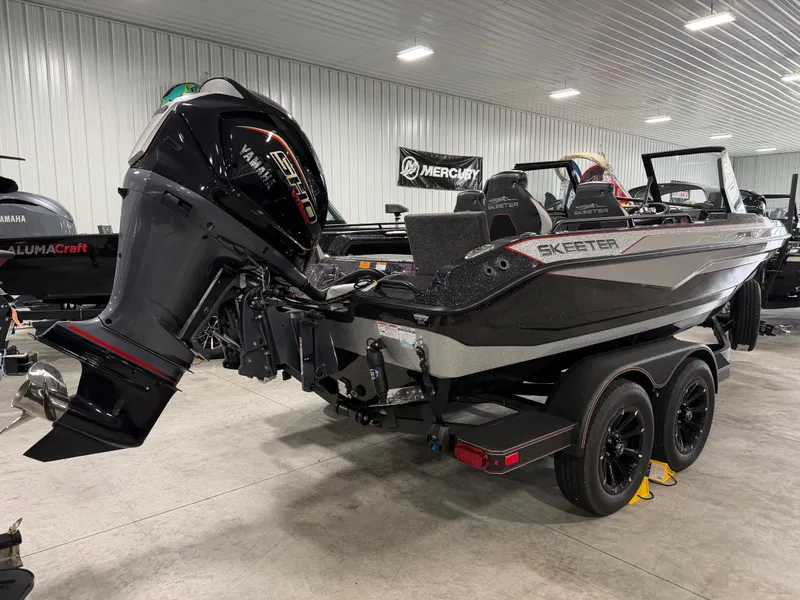Slide: The Image of A 2026 Skeeter WXR1910F boat is indoors. It features a powerful outboard motor. - 10
