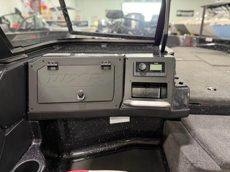 Slide: The Image of Dashboard of a Skeeter WXR1910F boat with controls and storage compartment. - 21