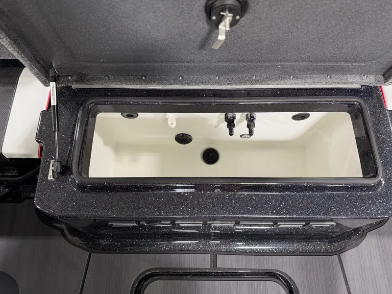 Slide: The Image of An open storage compartment with a black rim and white interior, featuring water fittings. - 34