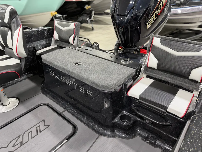 Slide: The Image of The image shows the interior of a Skeeter WXR1910F boat with cushioned seats and an engine. - 35