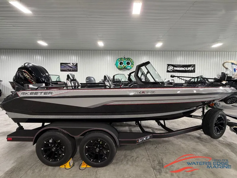 The Image of A 2026 Skeeter WXR1910F boat on a trailer inside a showroom. - 1