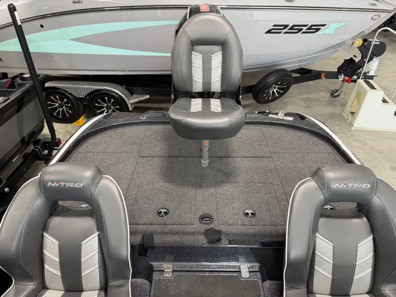 Slide: The Image of The image shows the cockpit of a 2024 Nitro Z20 Pro boat with gray seats. - 25