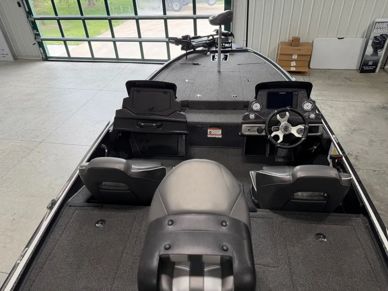 Slide: The Image of The image shows the cockpit of a 2024 Nitro Z20 Pro boat in a warehouse. - 32