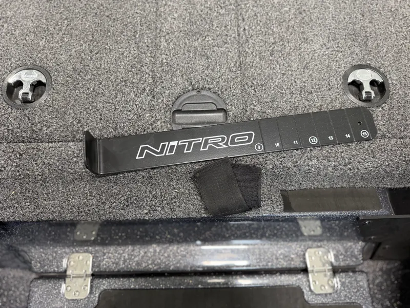 Slide: The Image of Close-up of a Nitro Z20 Pro boat deck with a measuring stick. - 26