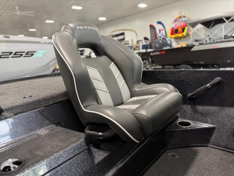 Slide: The Image of A gray seat in a modern boat, surrounded by other boats in a showroom. - 18