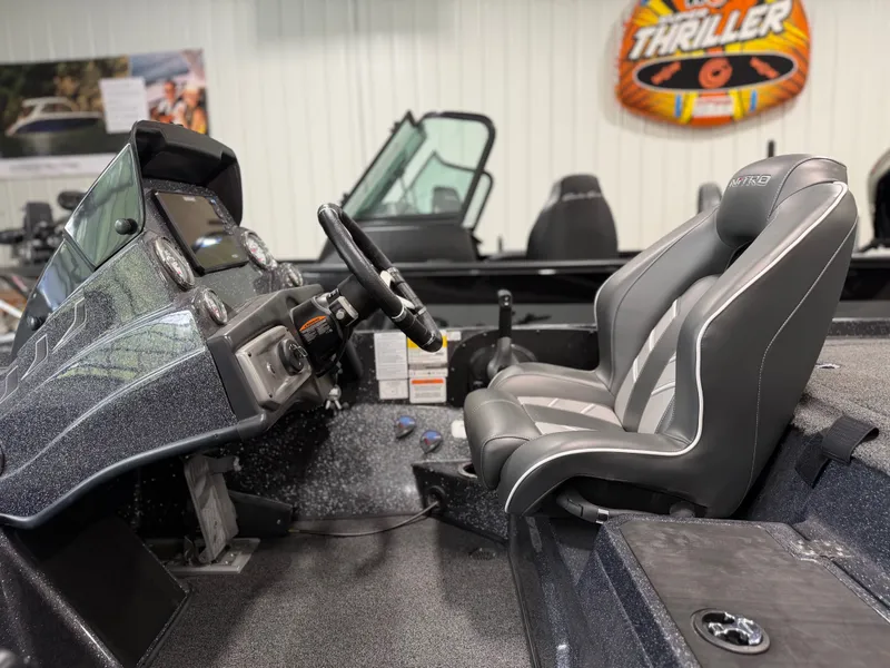 Slide: The Image of The image shows the cockpit of a 2024 Nitro Z20 Pro boat with gray seats. - 20