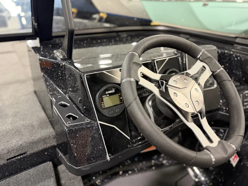 Slide: The Image of The image shows the cockpit of a Skeeter WXR2060 boat with a modern steering wheel and instruments. - 23
