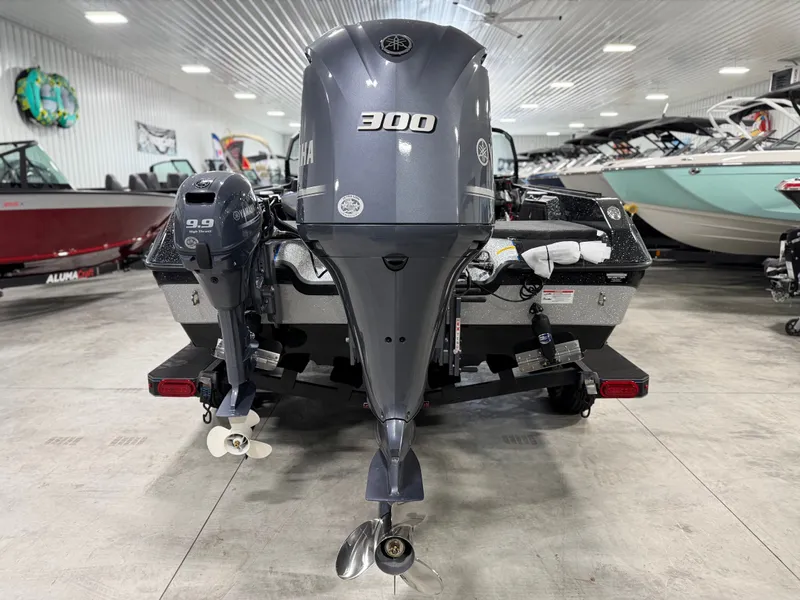 Slide: The Image of Rear view of a Skeeter WXR2060 with two outboard motors in a showroom. - 7