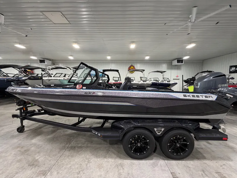 Slide: The Image of A 2026 Skeeter WXR2060 boat is on a trailer in a showroom. - 5