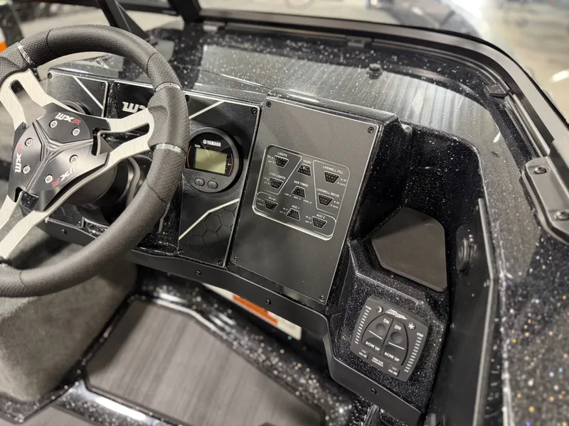 Slide: The Image of The image shows the cockpit of a Skeeter WXR2060 boat with a modern control area. - 25