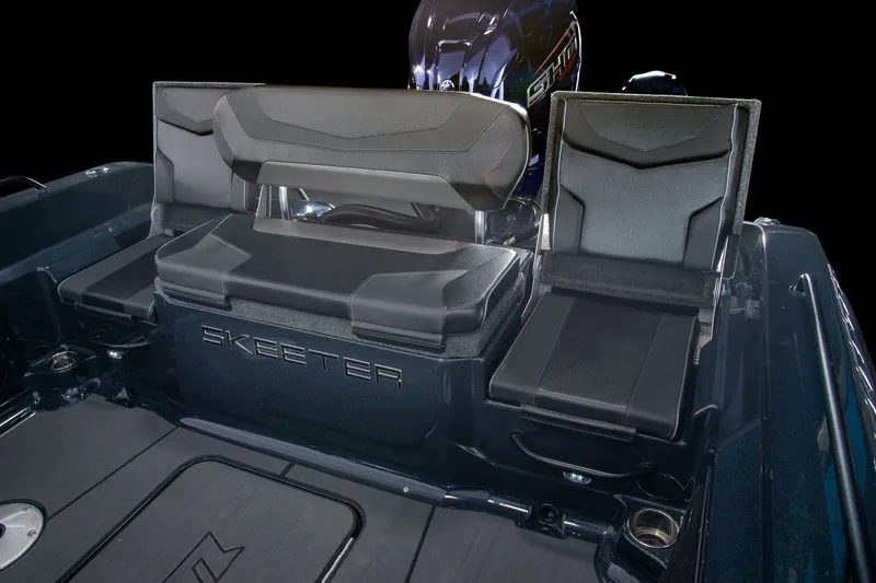 Slide: The Image of The image shows the interior of a Skeeter WXR2060 boat with black seating and an engine. - 48