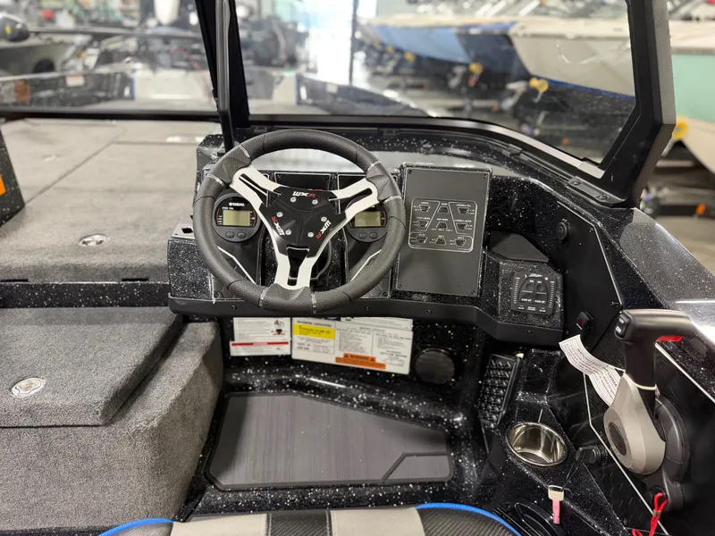 Slide: The Image of The image shows the cockpit of a Skeeter WXR2060 boat with a modern steering wheel and instruments. - 24