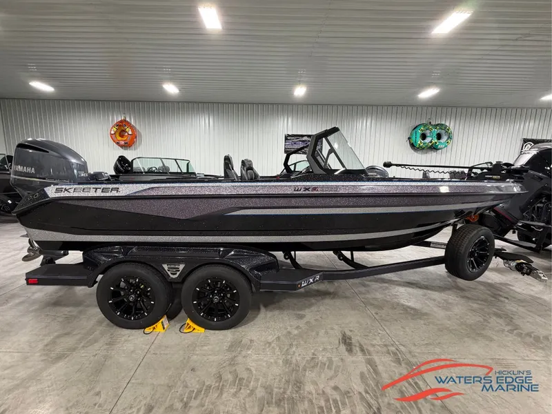 The Image of A 2026 Skeeter WXR2060 boat is on a trailer inside a warehouse. - 1