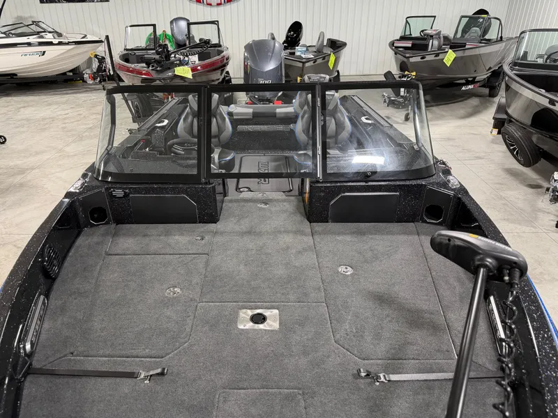 Slide: The Image of The image shows the interior of a 2026 Skeeter WXR2060 boat with gray carpeting. - 15