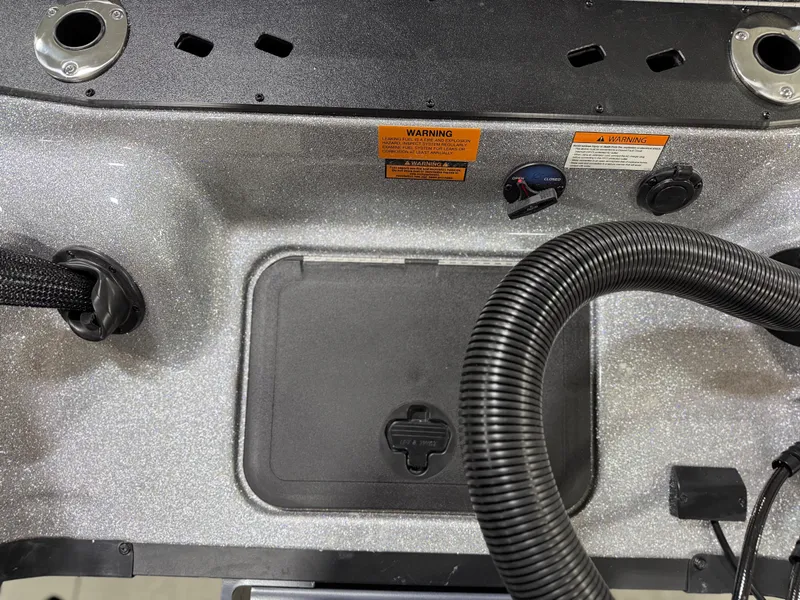 Slide: The Image of Close-up of a boat part with a black cover and hoses. - 30